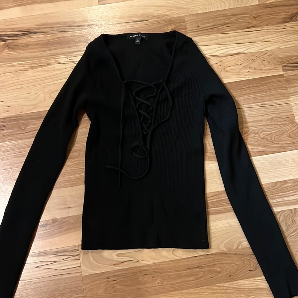Black long sleeve top with crosses in the middle